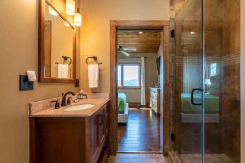 a bathroom with a sink and a glass shower at Grandfather Vistas in Blowing Rock