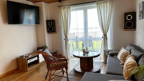 a living room with a couch and a table at Agroturystyka Widokówka Nielisz in Nielisz