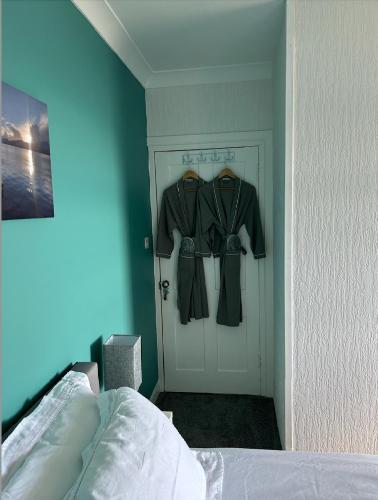 a room with a door with two coats hanging on it at Castle View in Lochaline