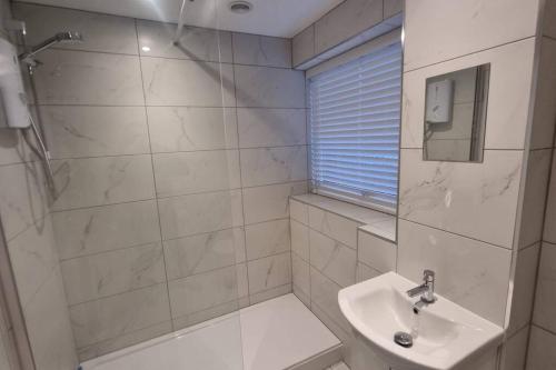 a bathroom with a shower and a sink at Spacious self contained flat in superb location in Lymington