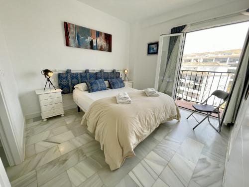 a bedroom with a large bed and a large window at Rincon del Mar Spacios 3 bedrooms apartment close to Calahonda Beach - Mijas Costa in Mijas Costa