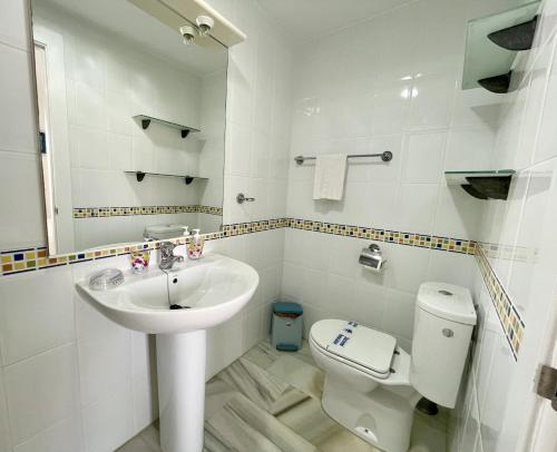 a white bathroom with a sink and a toilet at Rincon del Mar Spacios 3 bedrooms apartment close to Calahonda Beach - Mijas Costa in Mijas Costa