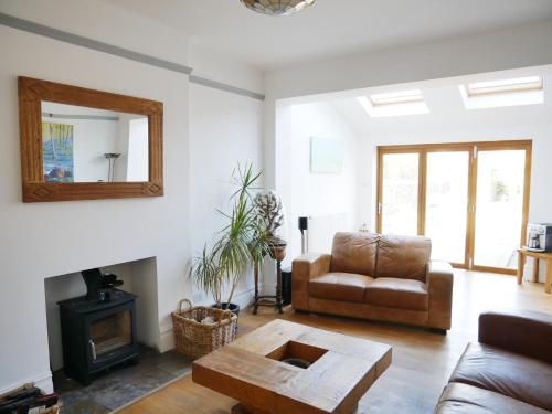 a living room with a couch and a table at Close to beaches and town, off street parking in Kent