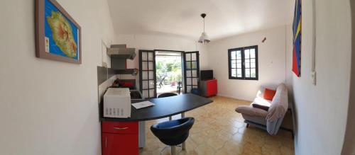 a room with a desk and a chair and a table at ESCAL RUN in Le Tampon