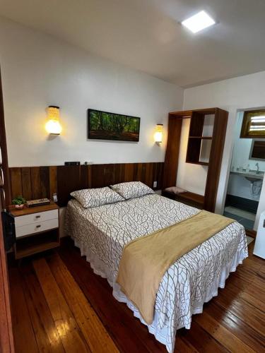 a bedroom with a bed and a tv on the wall at Casa de praia em Fortim CE com ótima localização e fácil acesso in Fortim