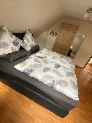 a bed with white sheets and pillows in a room at Ferienhaus Heidi in Bundenthal