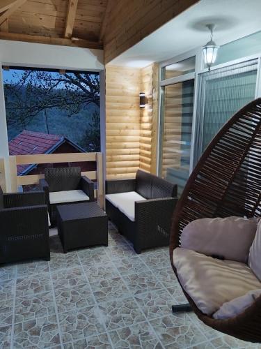 a patio with couches and chairs on a porch at Stari Hrast 2 in Prolomska Banja