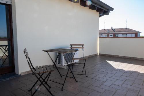 a patio with two chairs and a table on a balcony at Parma Parco Ducale Duplex Apartment with parking in Parma