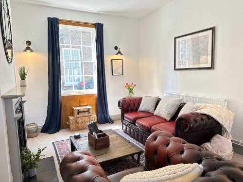 a living room with a couch and a table at Quayside Georgian Townhouse in King's Lynn