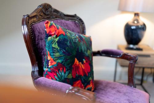 a colorful chair with a bird on it at No11 Boutique Hotel & Brasserie in Edinburgh