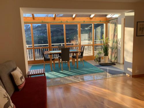 a living room with a table and chairs and a balcony at Apartment Schmiderer in Landeck