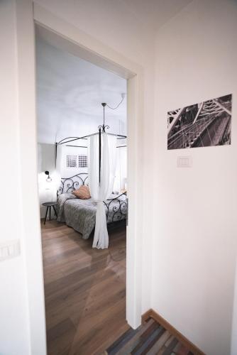 a bedroom with a bed with a canopy at Verrazzano 37 Guest House in Rome