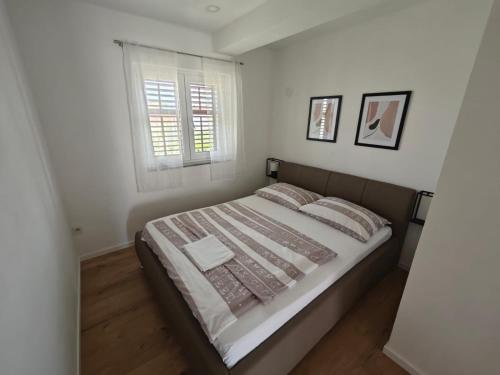 a bedroom with a large bed and a window at Two person apartment in Nin