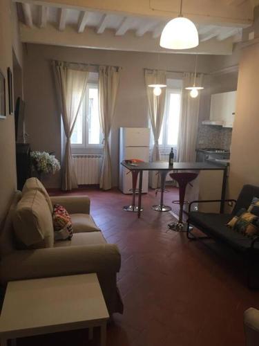 a living room with a couch and a table at Living in centro storico in Florence