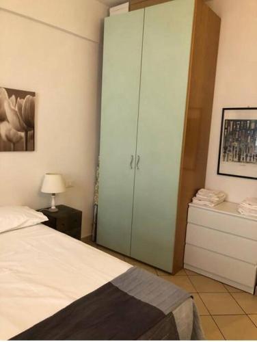a bedroom with a bed and a large cabinet at Living in centro storico in Florence