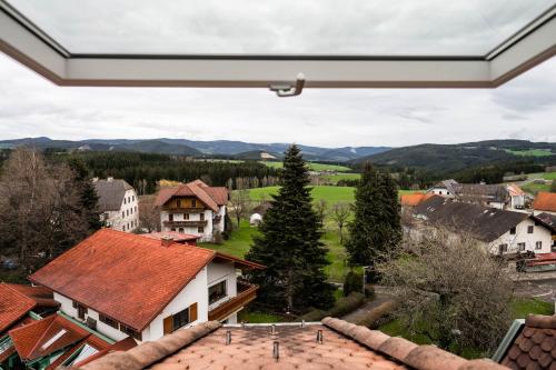 a view of a village from a window of a house at PANORAMA SportHOTEL in Wenigzell