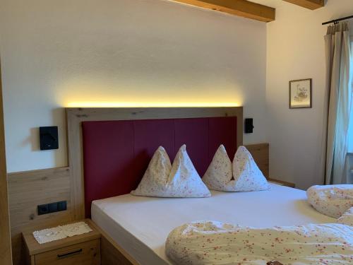 1 dormitorio con 1 cama con 2 almohadas en Garni & Residence Sonngart, en Lagundo