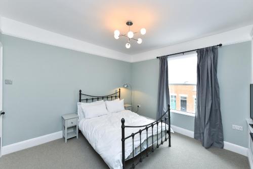 a bedroom with a bed and a window at Highfield Grove - Beautifully Bright 2BR, West Bridgford in Nottingham