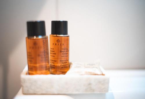 two bottles of essential oils are sitting on a shelf at Verrazzano 37 Guest House in Rome