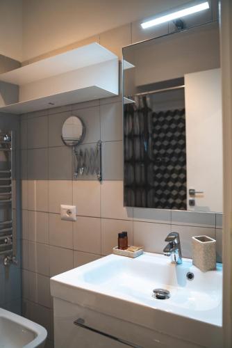 a bathroom with a sink and a mirror at Verrazzano 37 Guest House in Rome