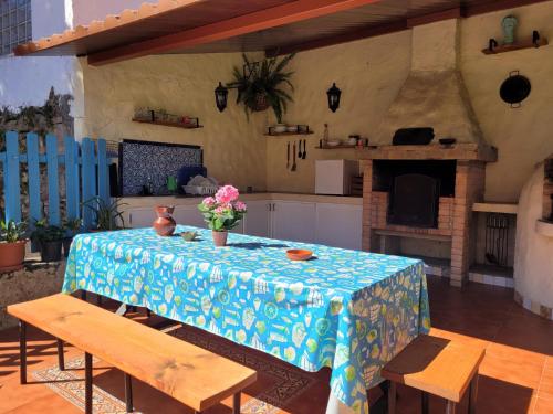 a kitchen with a table with a blue and white table cloth at Castaño Bajo - Santa Brigida in Santa Brígida