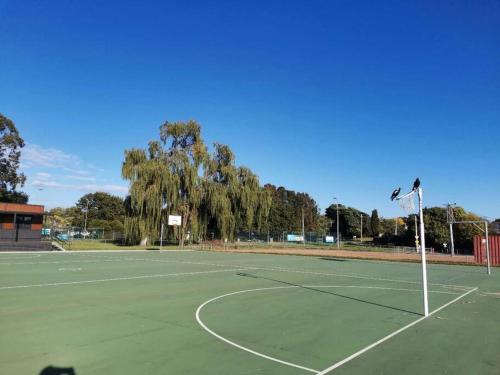 a tennis court with a net on top of it at Parliament Triangle * Garden View in Yarralumla