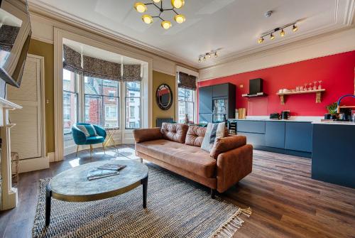 a living room with a couch and a table at Casa Del Artista , Boutique Apartments, Whitby in Whitby