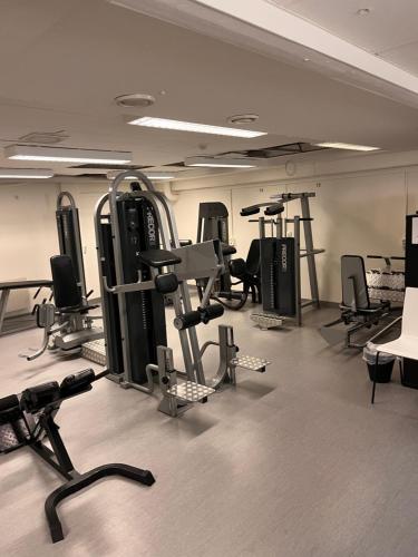 a gym with several exercise equipment in a room at Rentalux Hostel in Timrå