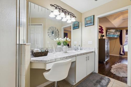 a bathroom with a sink and a mirror at Master Guest Suite with Pool and Private Entrance Minutes to Parks in Orlando