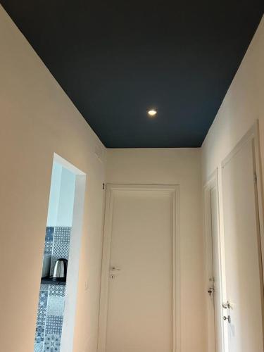 a room with a black ceiling and a door at ACCADEMIA Rooms in Livorno
