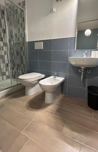 a bathroom with a toilet and a sink at ACCADEMIA Rooms in Livorno