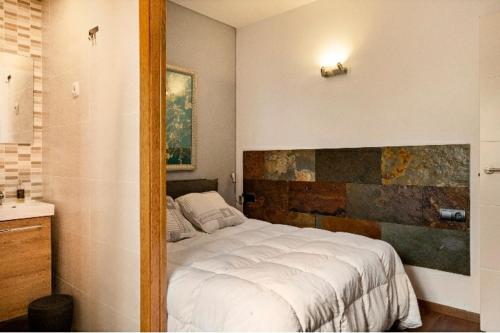 a bedroom with a large white bed in it at Villanoelia Beach No fiestas in Cambrils