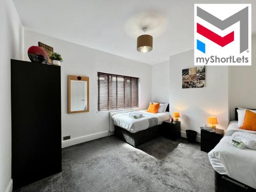 a bedroom with two beds and a window at Johnson House - Great for Contractors or Family Holidays in Cleethorpes