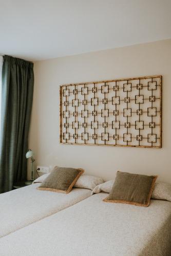 a bedroom with a bed with two pillows on it at Mares - Bellamar in Torre del Mar