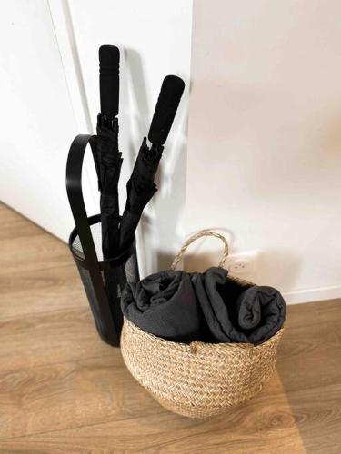 a basket sitting on a wooden floor with a blanket at « Hortense » in Soorts-Hossegor