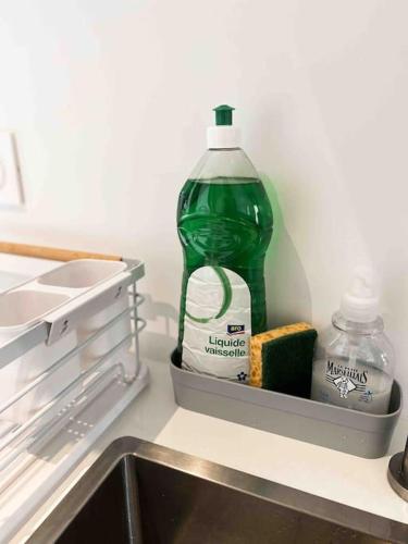 a bottle of detergent and a bottle of milk in a refrigerator at « Hortense » in Soorts-Hossegor