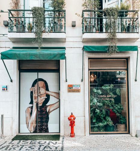 a store front with a picture of a woman in the window at Lisbon Art Stay Apartments Baixa in Lisbon