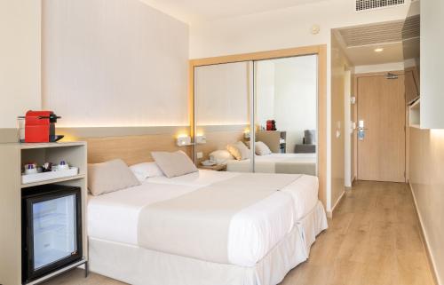Un ou plusieurs lits dans un hébergement de l'établissement Hotel Samos
