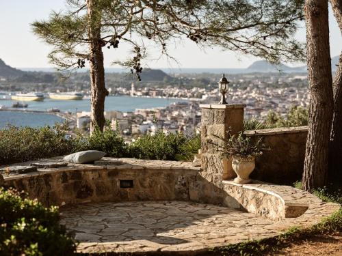 a stone bench with a view of a city at Villa Anatoli - Tranquil Escape with Scenic Views, by ZanteWize in Akrotiri