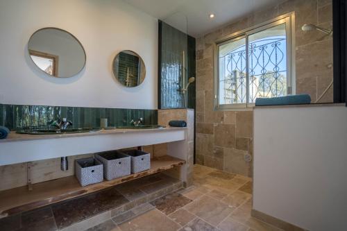 a bathroom with a sink and a mirror at VILLA L'ESTEREL AVEC PISCINE VUE MER -MANDELIEU 06210- 6 Pers in Fréjus