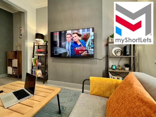 a living room with a tv on a wall at Daubney House - Great for Contractors or Family Holidays in Cleethorpes