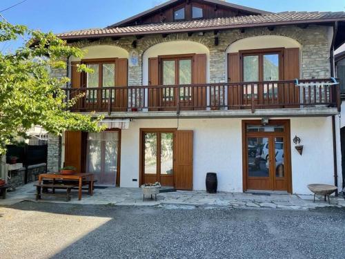 a large house with a deck on top of it at La Villetta di Oulx in Oulx