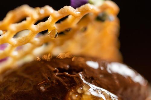 a close up of a plate of food with waffles at No11 Boutique Hotel & Brasserie in Edinburgh
