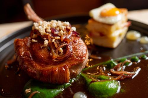 a plate of food with a piece of meat and a dessert at No11 Boutique Hotel & Brasserie in Edinburgh