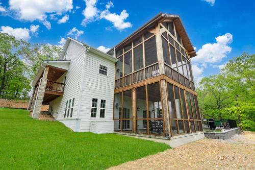 a house with glass windows and a building at Cedarwood Farmstead in Ridgedale