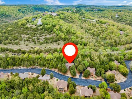 an aerial view of a house with a red circle in the air at Local Hero Lodge in Reeds Spring