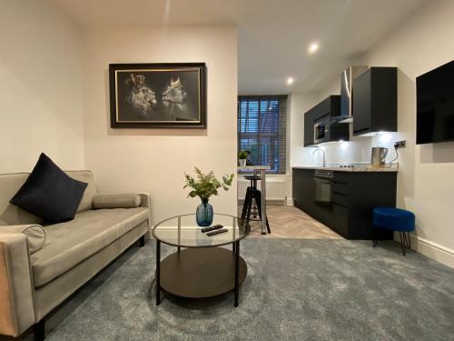 a living room with a couch and a table at Sun Street Aparthotel in Lancaster