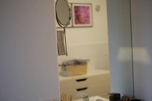 a bathroom with a mirror and a sink at Le Gîte de la Gray House in Mettet