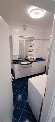 a kitchen with a counter and a blue tile floor at Vista Capodistria in Koper
