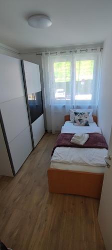 a bedroom with a bed and two windows at Vista Capodistria in Koper